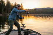 Angler casting baitcasting rod on lake at golden hour